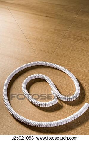 Stock Image - Telephone Cord Making 'At' Symbol. Fotosearch