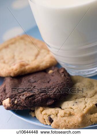 Stock Photo - Three Cookies On A Plate With A Glass Of Milk. Fotosearch