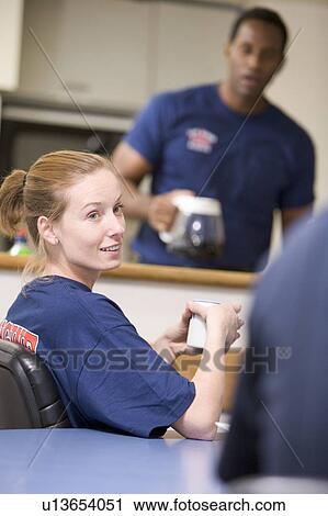 Three firefighters in break room with one getting coffee in background (selective focus) View Large Photo Image Stock Image - Three firefighters in break room with one getting coffee in background (selective focus). Fotosearch