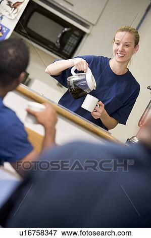 Three firefighters in break room with one getting coffee (selective focus) View Large Photo Image Stock Photo - Three firefighters in break room with one getting coffee (selective focus). Fotosearch