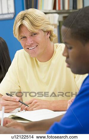 Three people in library studying (selective focus) View Large Photo Image Picture - Three people in library studying (selective focus). Fotosearch