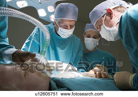 Three Surgeons Operating On A Patient View Large Photo Image Stock Image - Three Surgeons Operating On A Patient. Fotosearch