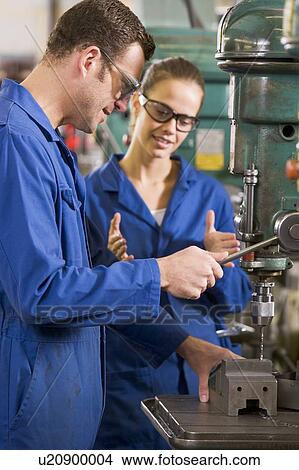 Two machinists working on machine View Large Photo Image Picture - Two machinists working on machine. Fotosearch