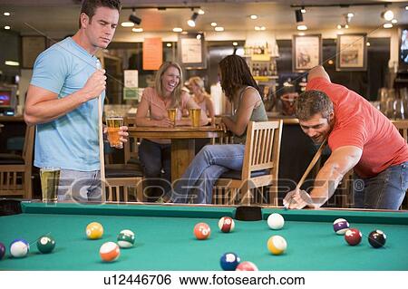 Two men playing pool View Large Photo Image Stock Photograph - Two men playing pool. Fotosearch