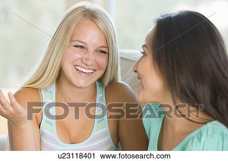 Stock Image - Two Teenage Girls Smiling To Each Other . Fotosearch