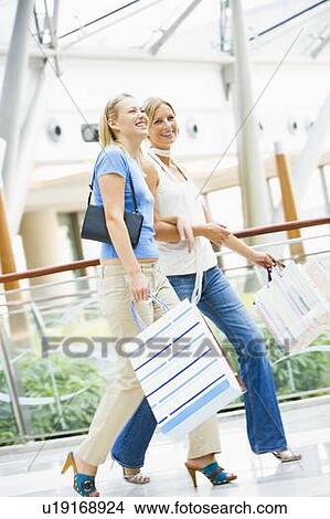 Picture - Two women at a shopping mall. Fotosearch