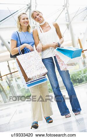Two women at a shopping mall View Large Photo Image Stock Image - Two women at a shopping mall. Fotosearch