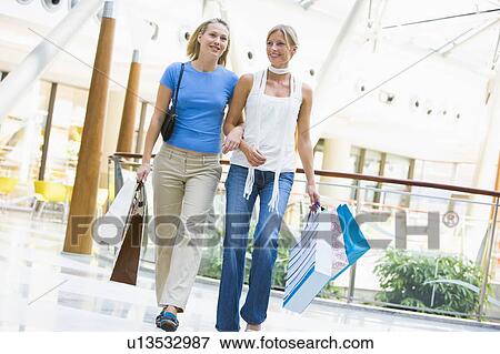 Stock Photo - Two women at a shopping mall. Fotosearch
