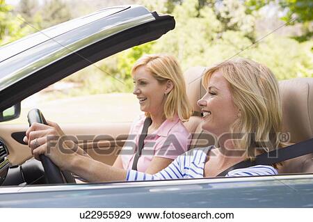 Two women in convertible car smiling View Large Photo Image Stock Photo - Two women in convertible car smiling. Fotosearch