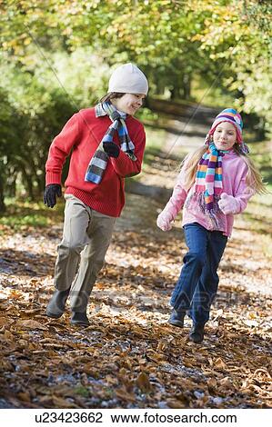 Two young children running on path outdoors smiling (selective focus) View Large Photo Image Stock Image - Two young children running on path outdoors smiling (selective focus). Fotosearch