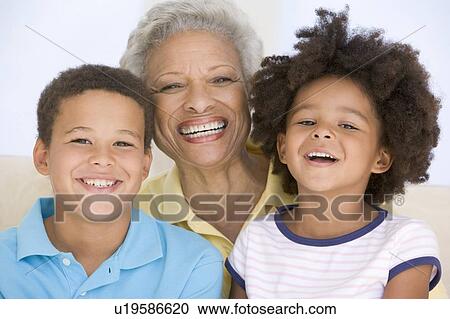 Woman and two young children smiling View Large Photo Image Stock Image - Woman and two young children smiling. Fotosearch