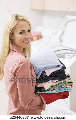 Woman Carrying Folded Up Laundry View Large Photo Image Stock Photo - Woman Carrying Folded Up Laundry. Fotosearch