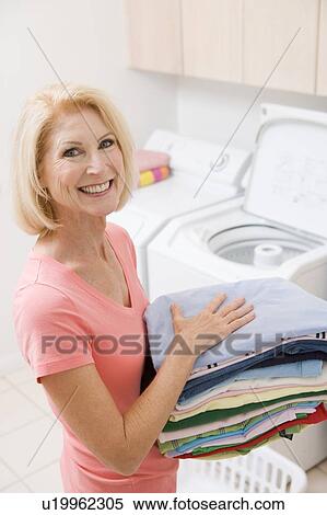 Woman Carrying Folded Up Laundry View Large Photo Image Stock Photography - Woman Carrying Folded Up Laundry. Fotosearch