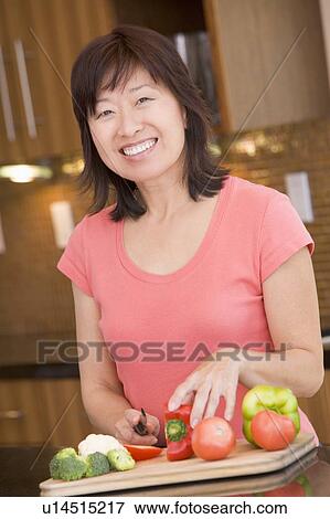 Stock Photo - Woman Chopping Vegetables. Fotosearch