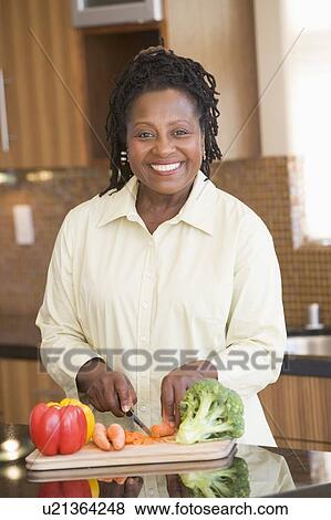 Stock Photo - Woman Chopping Vegetables. Fotosearch