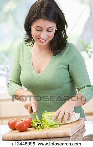 Stock Photography - Woman Chopping Vegetables. Fotosearch