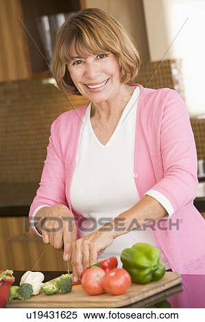 Stock Photography - Woman Chopping Vegetables. Fotosearch