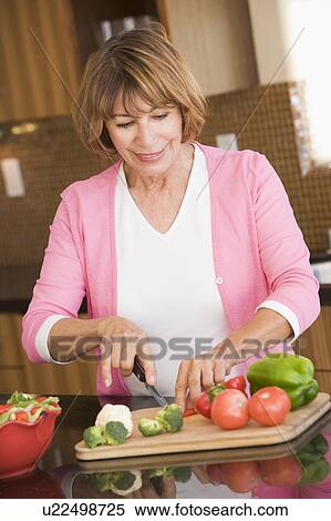 Stock Photography - Woman Chopping Vegetables. Fotosearch