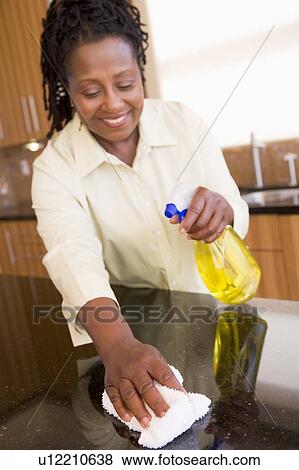 Woman Cleaning Kitchen Counter View Large Photo Image Stock Photo - Woman Cleaning Kitchen Counter. Fotosearch