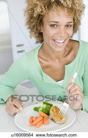 Woman Eating Healthy meal, mealtime View Large Photo Image Picture - Woman Eating Healthy meal, mealtime. Fotosearch