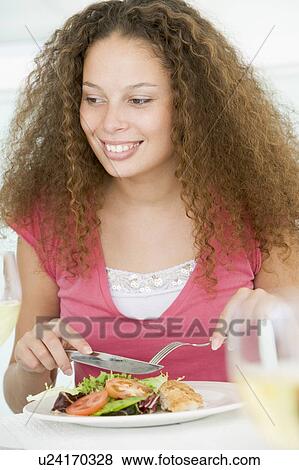 Woman Eating Healthy meal, mealtime View Large Photo Image Stock Photo - Woman Eating Healthy meal, mealtime. Fotosearch