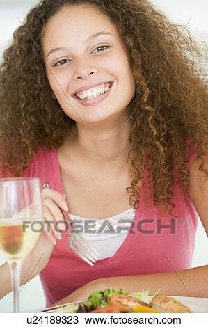 Woman Eating meal, mealtime With A Glass Of Wine View Large Photo Image Stock Image - Woman Eating meal, mealtime With A Glass Of Wine . Fotosearch