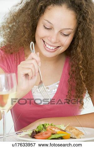 Woman Eating meal, mealtime With A Glass Of Wine View Large Photo Image Stock Photo - Woman Eating meal, mealtime With A Glass Of Wine . Fotosearch