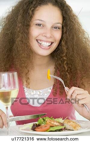 Woman Eating meal, mealtime With A Glass Of Wine View Large Photo Image Stock Photograph - Woman Eating meal, mealtime With A Glass Of Wine . Fotosearch