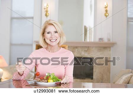 Woman Enjoying Healthy meal, mealtime View Large Photo Image Stock Image - Woman Enjoying Healthy meal, mealtime. Fotosearch