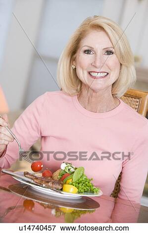 Woman Enjoying Healthy meal, mealtime View Large Photo Image Stock Photo - Woman Enjoying Healthy meal, mealtime. Fotosearch