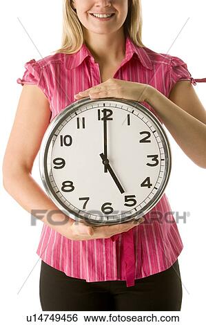 Stock Photograph - Woman Holding Clock. Fotosearch