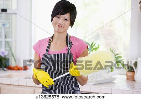 Woman Holding Duster And Wearing Rubber Gloves View Large Photo Image Stock Photo - Woman Holding Duster And Wearing Rubber Gloves. Fotosearch