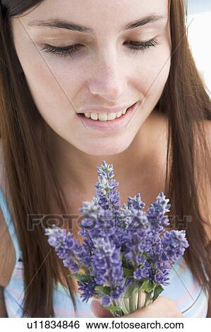 Woman holding flowers View Large Photo Image Stock Photograph - Woman holding flowers. Fotosearch