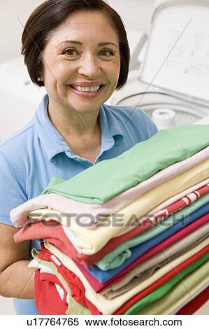 Woman Holding Folded Laundry View Large Photo Image Stock Photography - Woman Holding Folded Laundry. Fotosearch