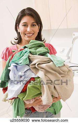 Woman Holding Pile Of Laundry View Large Photo Image Stock Image - Woman Holding Pile Of Laundry. Fotosearch