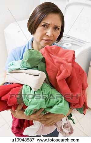 Stock Photo - Woman Holding Pile Of Laundry. Fotosearch