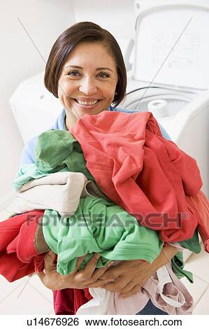 Woman Holding Pile Of Laundry View Large Photo Image Stock Photograph - Woman Holding Pile Of Laundry. Fotosearch
