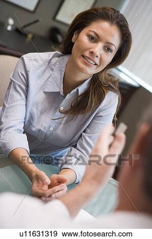 Stock Photo - Woman in consultation at IVF clinic (selective focus). Fotosearch