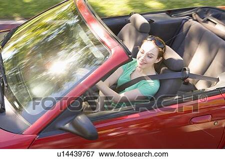 Woman in convertible car smiling View Large Photo Image Stock Photo - Woman in convertible car smiling. Fotosearch