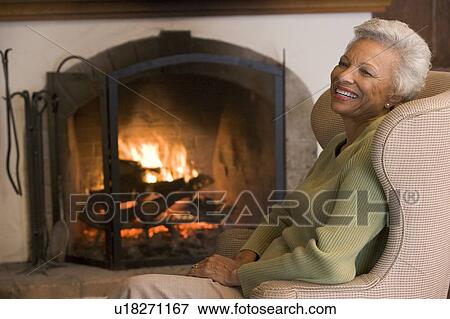 Stock Photo - Woman in living room laughing. Fotosearch