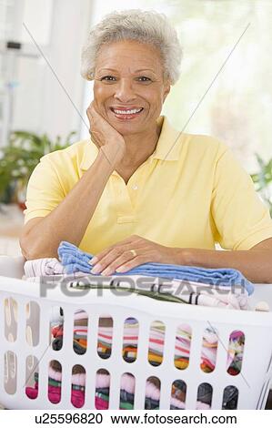 Woman Leaning On Washing Basket View Large Photo Image Stock Image - Woman Leaning On Washing Basket . Fotosearch