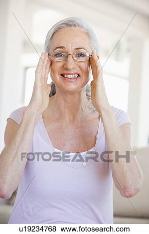Stock Photo - Woman Looking Through New Glasses. Fotosearch