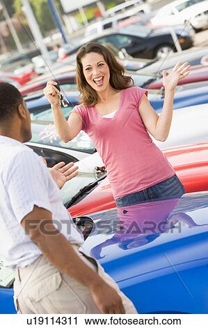 Stock Image - Woman shopping for a new car. Fotosearch