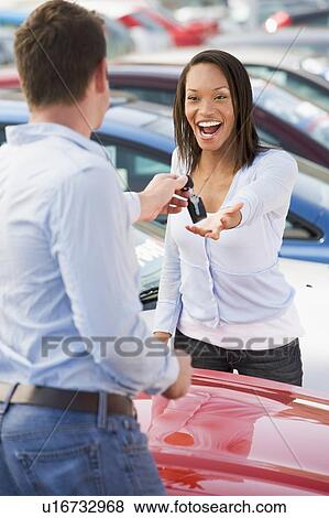 Stock Photo - Woman shopping for a new car. Fotosearch