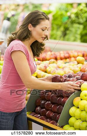 Woman shopping for apples at a grocery store View Large Photo Image Stock Image - Woman shopping for apples at a grocery store. Fotosearch