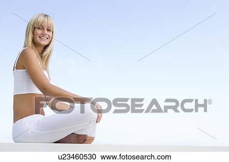 Woman sitting and meditating outdoors View Large Photo Image Stock Image - Woman sitting and meditating outdoors. Fotosearch
