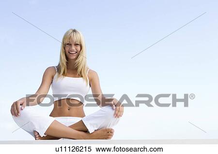 Woman sitting and meditating outdoors View Large Photo Image Stock Photography - Woman sitting and meditating outdoors. Fotosearch