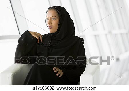 Woman sitting indoors (high key/selective focus) View Large Photo Image Stock Image - Woman sitting indoors (high key/selective focus). Fotosearch