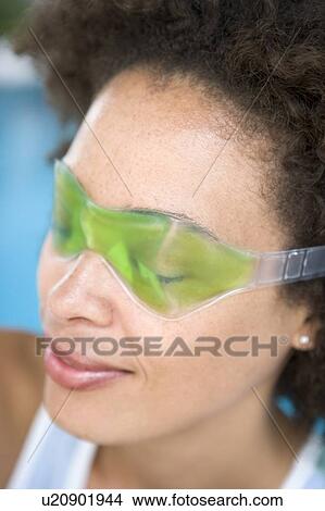 Woman sitting poolside using eye mask View Large Photo Image Picture - Woman sitting poolside using eye mask. Fotosearch