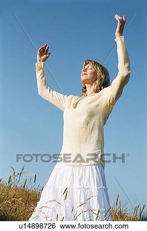 Woman standing outdoors View Large Photo Image Stock Photograph - Woman standing outdoors. Fotosearch
